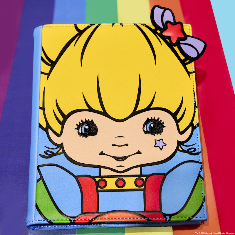 Loungefly Rainbow Brite Cosplay Refillable Stationery Journal featuring Rainbow Brite on the cover sitting on a rainbow with a blue background. 